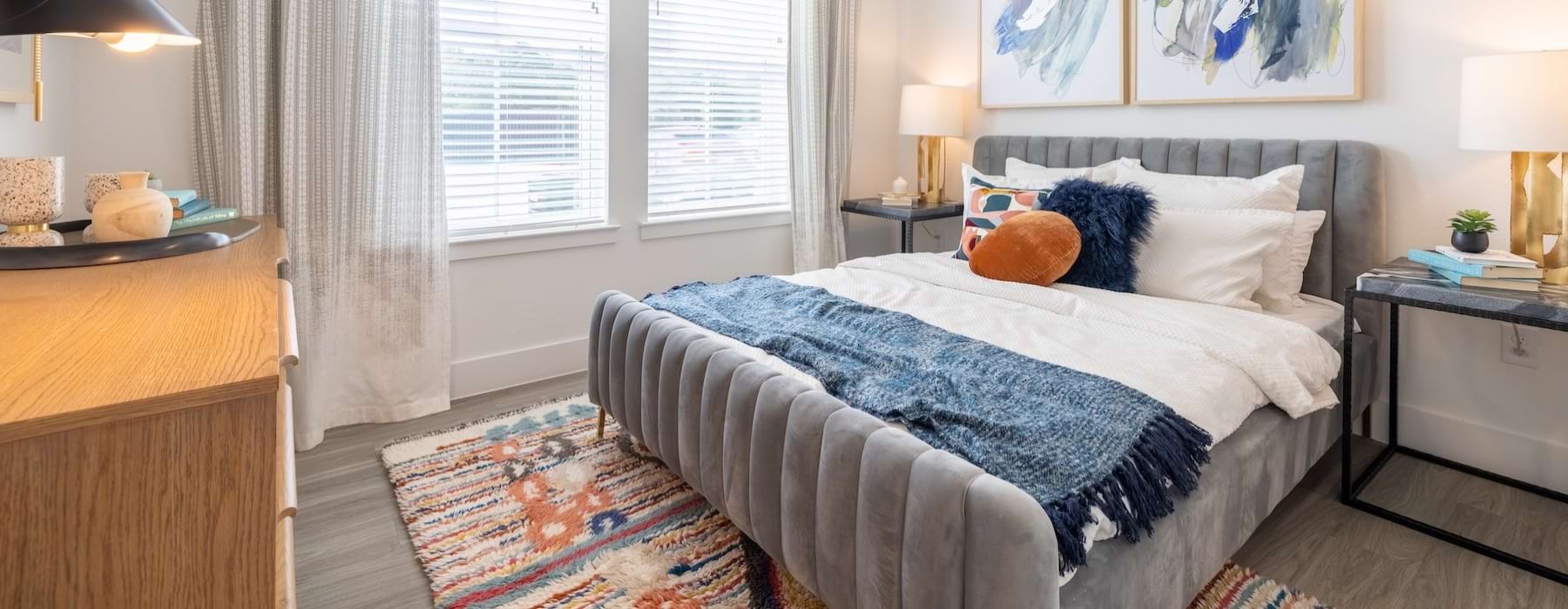 a bedroom with a bed and a fan