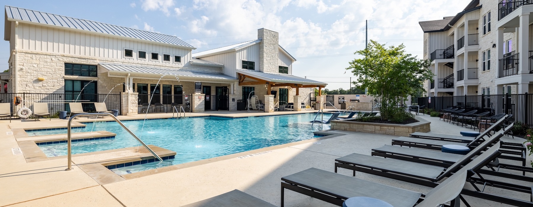 a swimming pool with lounge chairs