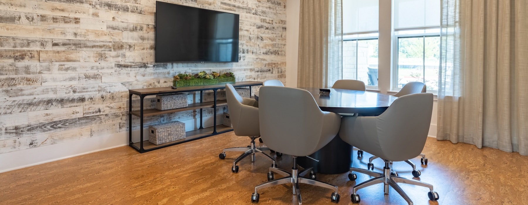a room with chairs and a tv
